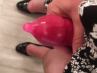 Masturbating in a condom and  heels and a dress