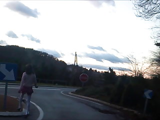 Al aire libre schoolgirl flashing on traffic circle roadsigns plugged