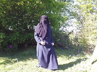 Muslim in burqa and stockings – flashing outdoors